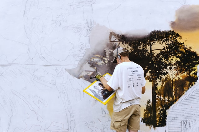 Professional mural artists painting to save desolate cities.